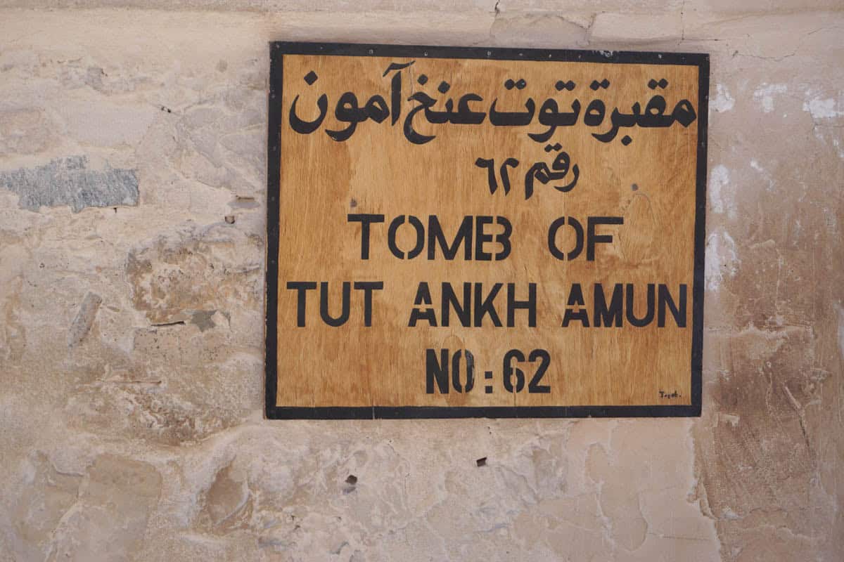 A bilingual sign identifies the Tomb of Tutankhamun, KV62, in the Valley of the Kings, Luxor, Egypt.