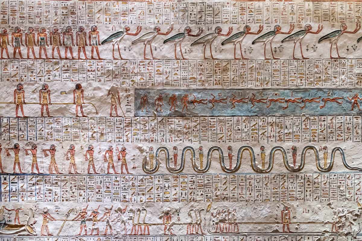 An illustrated funerary text with figures, birds, boats, and serpents in the Valley of the Kings, Luxor, Egypt.