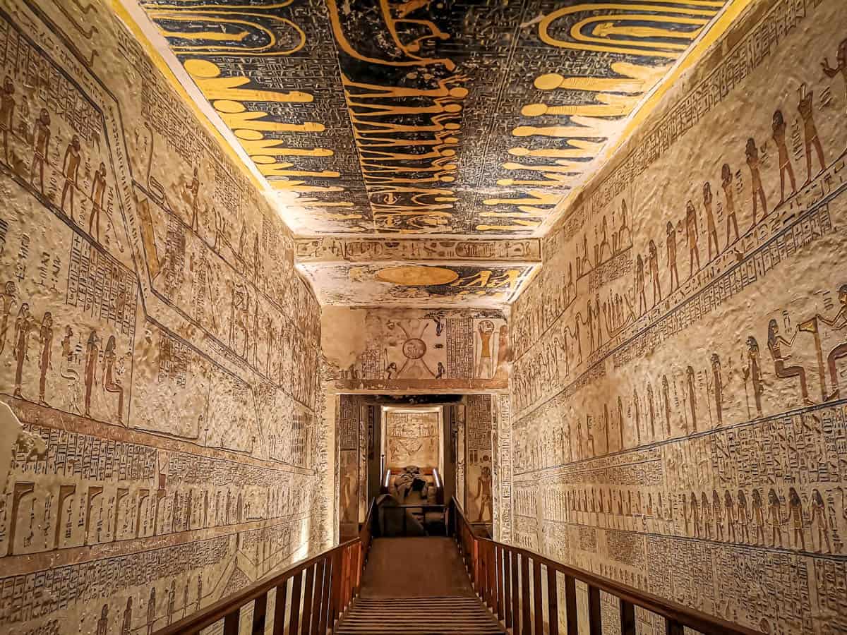 A wooden walkway descending between inscribed tomb walls in the Valley of the Kings, Luxor, Egypt.